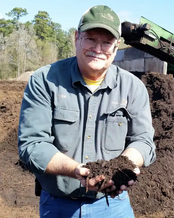 john ferguson with soil in his hands at natures way resources