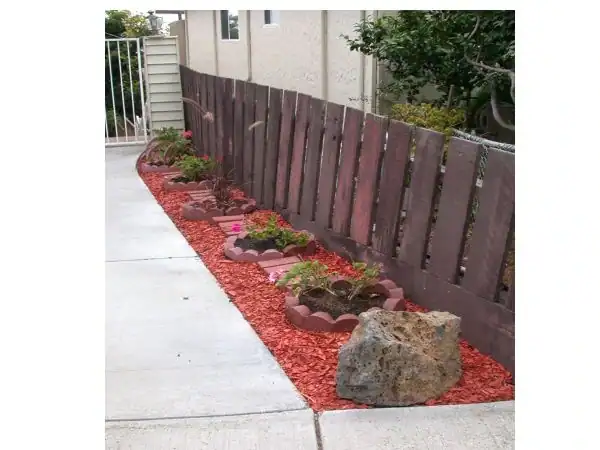 red mulch fire hazard near wooden fence and house