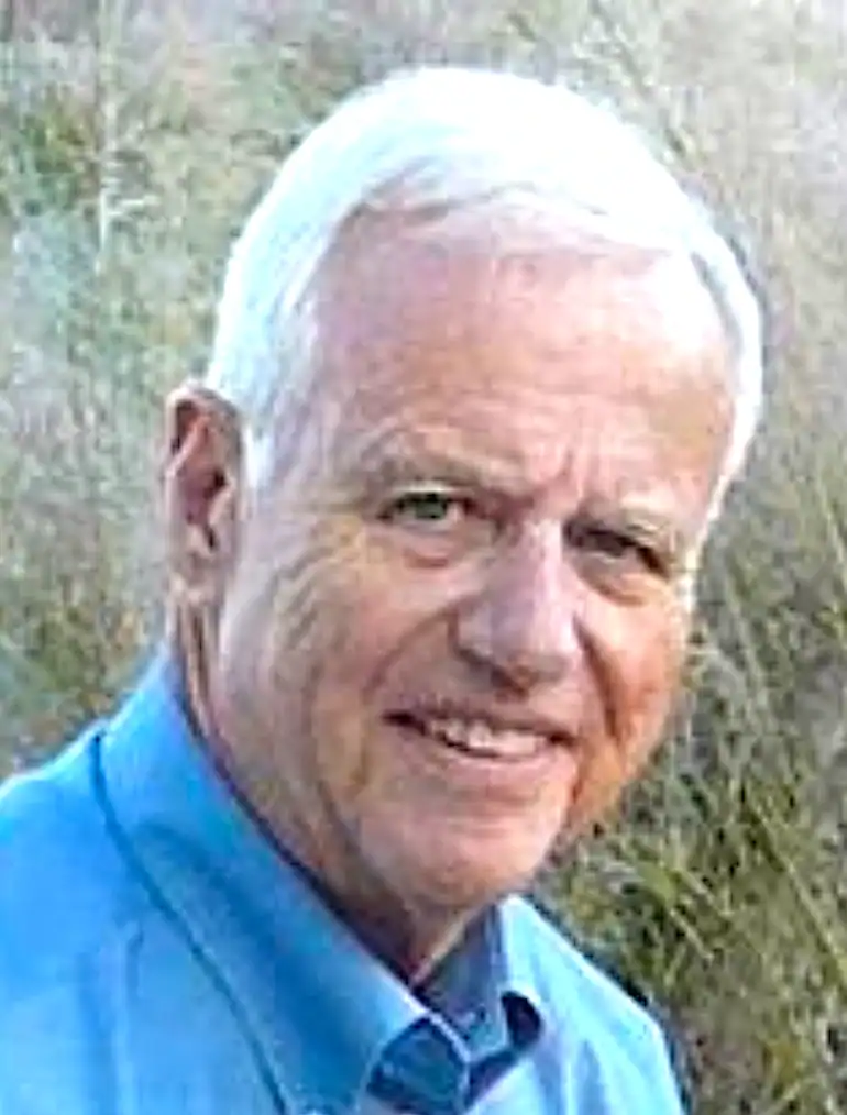 Smiling man with white hair
