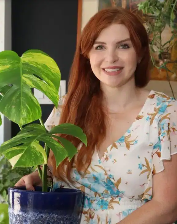 Woman with plant in blue pot